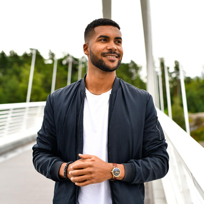 Men standing on the bridge with blue jacket and adventurister gold