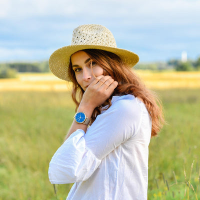 Women with hat and white shirt on the field